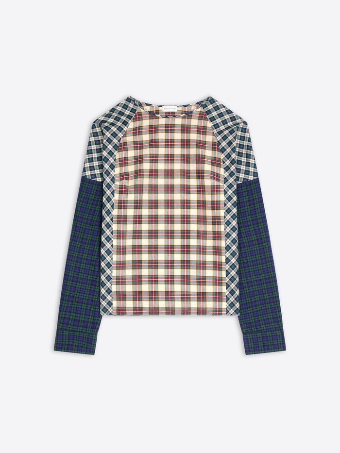 A long-sleeve raglan top with a multi-colored plaid pattern, featuring a cream and red checkered center body, green and white checkered shoulder yokes, and solid dark green plaid sleeves, shown flat on a light gray background.