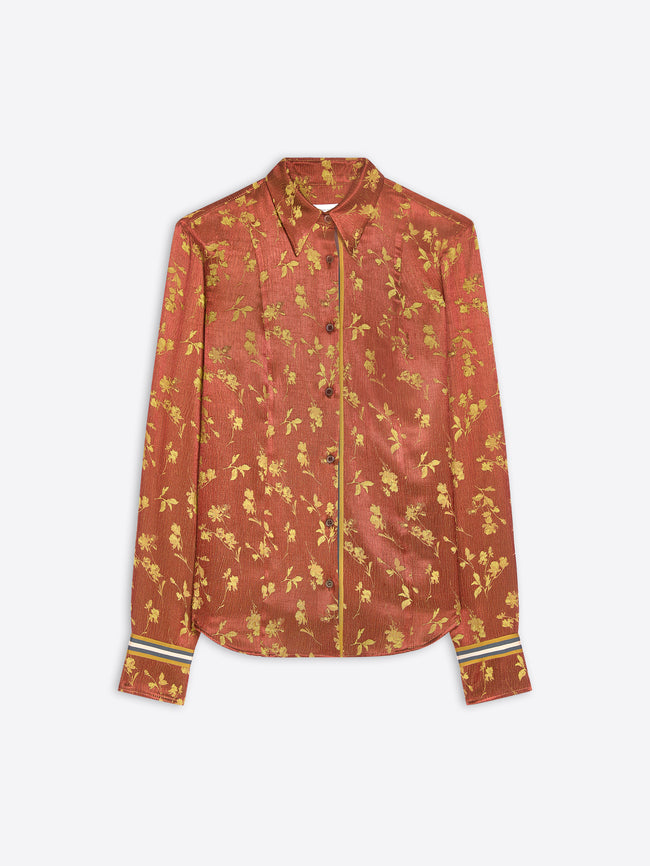 A long-sleeve button-up shirt in rust-orange silk with an all-over gold floral pattern, featuring striped cuff details.