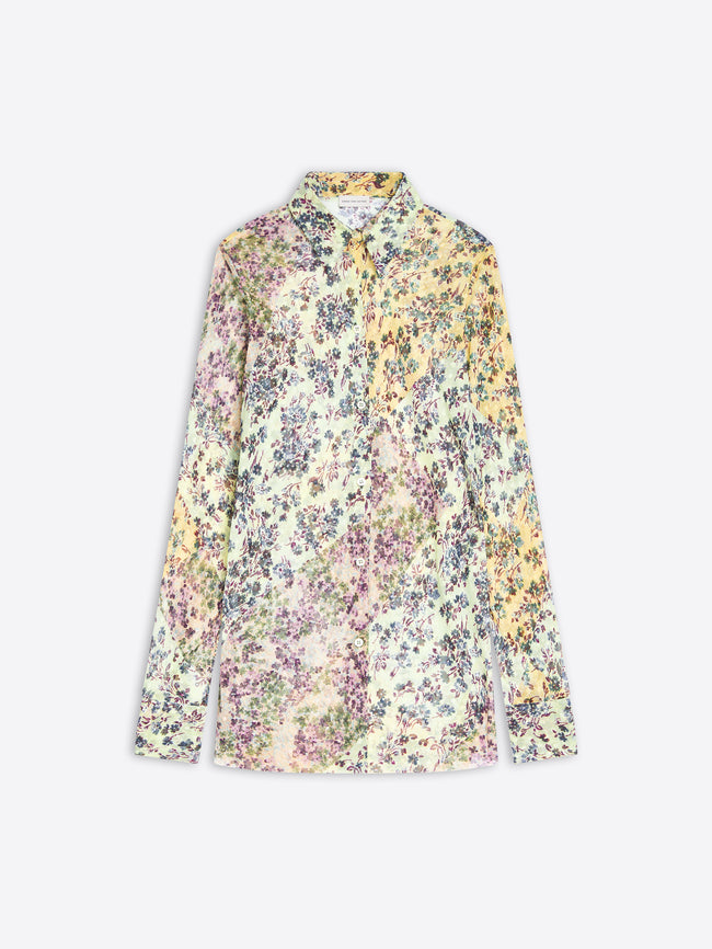 A long-sleeve button-up shirt with a dense, multicolor floral print on a pastel mint base, featuring yellow, purple, and blue flowers, displayed against a light gray background.