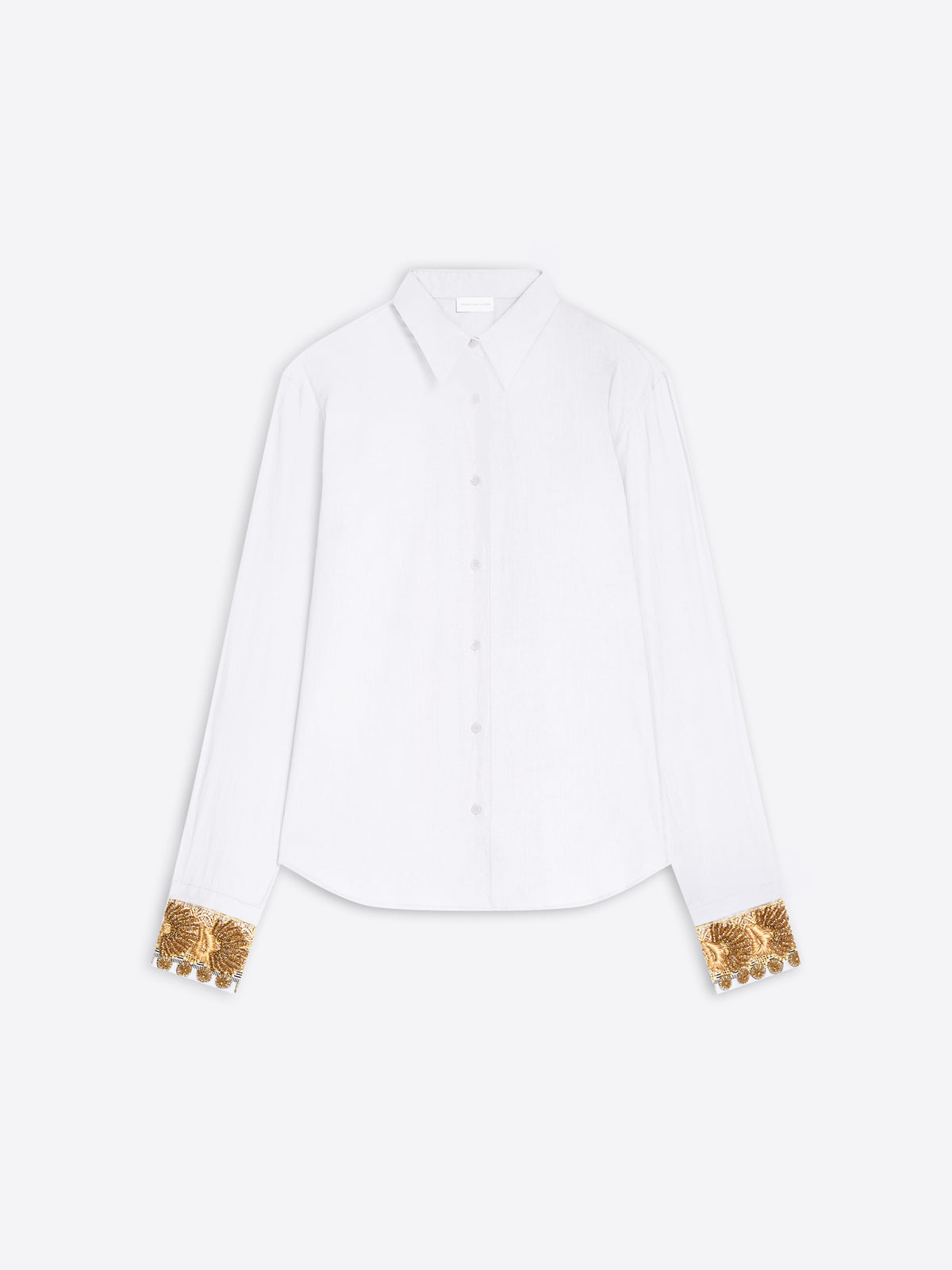 A white long-sleeve button-up shirt with ornate gold sequined cuff details, displayed flat against a light gray background.