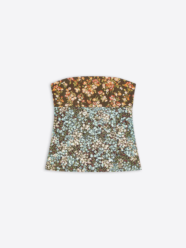 A strapless bandeau top with a split floral pattern, featuring a dark brown top half with orange and cream flowers, and a light blue and cream bottom half, shown on a light gray background.