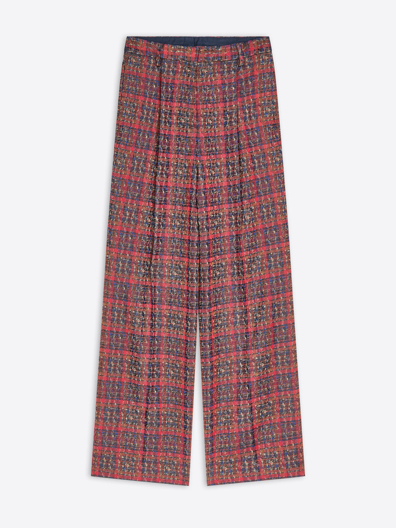 A pair of wide-leg trousers featuring a dense, small-scale multicolor pattern, laid flat against a light gray background.