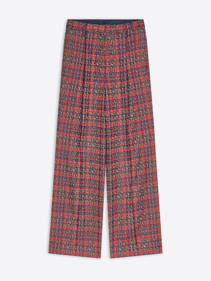 A pair of wide-leg trousers featuring a dense, small-scale multicolor pattern, laid flat against a light gray background.