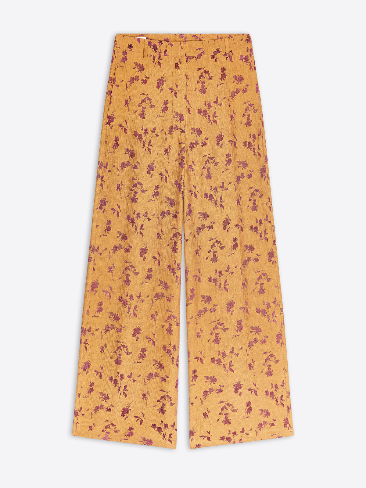Ochre-colored wide-leg trousers with a small purple floral pattern, shown flat against a light gray background.