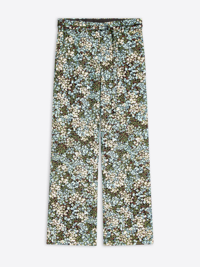 Wide-leg pants featuring an all-over dense floral print on a light gray background 