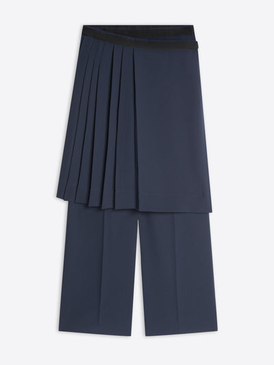A pair of navy blue wide-leg cropped pants featuring a layered dark navy pleated skirt.