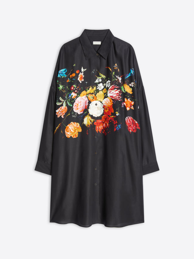 A black long-sleeve shirt dress with a vibrant, multicolored floral print across the chest, displayed on a light gray background.