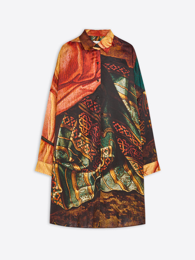 A long-sleeve collared shirt dress featuring an abstract, painterly print, displayed against a light gray background.