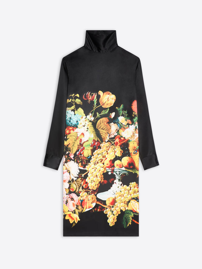 A black long-sleeve mock-neck dress featuring a large, vibrant  floral and fruit print on the front, displayed against a light gray background.