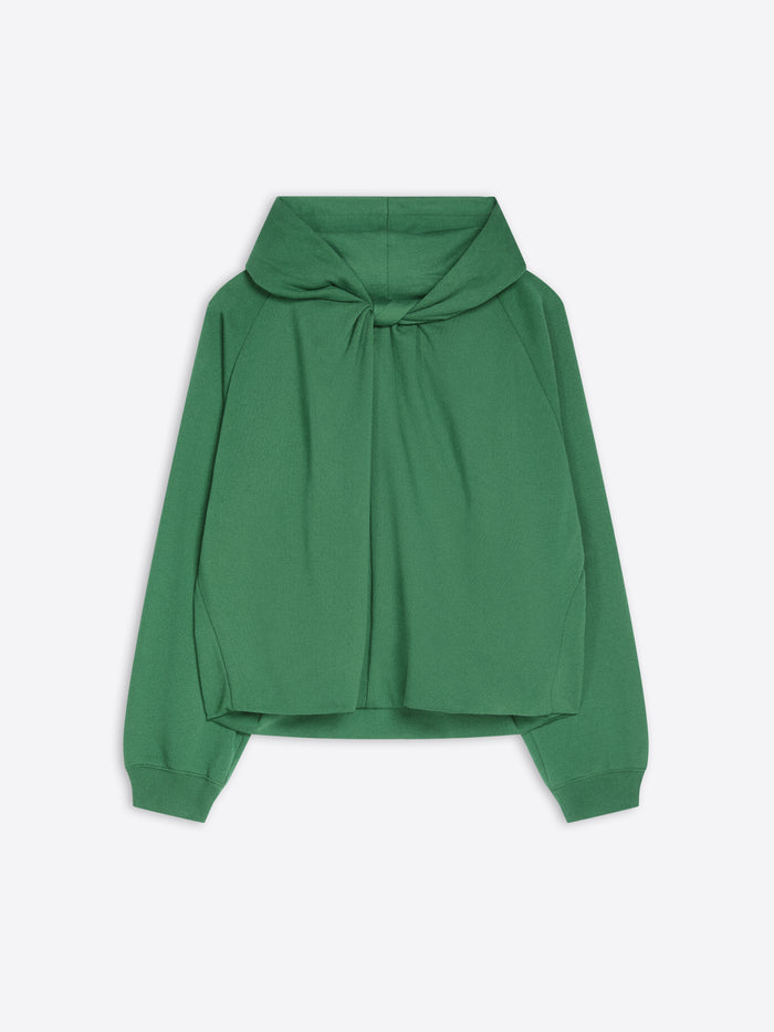 A green long-sleeve cropped hoodie with a draped, oversized front and a knotted tie detail at the neckline, shown against a light gray background.