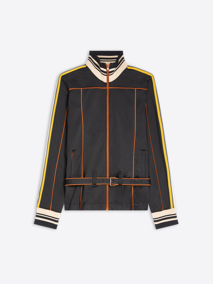 A black zip-up track jacket with cream and yellow stripe details on the shoulders, sleeves, and cuffs, and orange piping accents, shown against a light gray background.