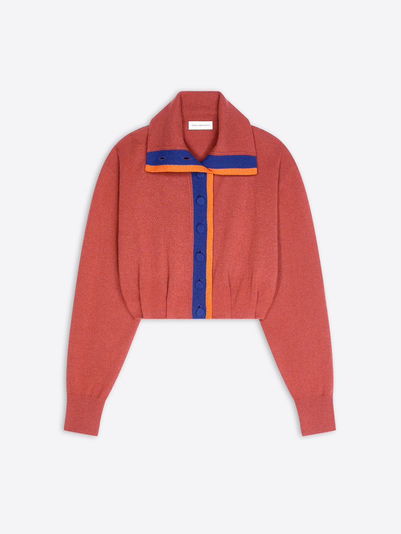 A cropped knit cardigan in a muted terracotta, featuring a wide collar with blue and orange striped collar and trim