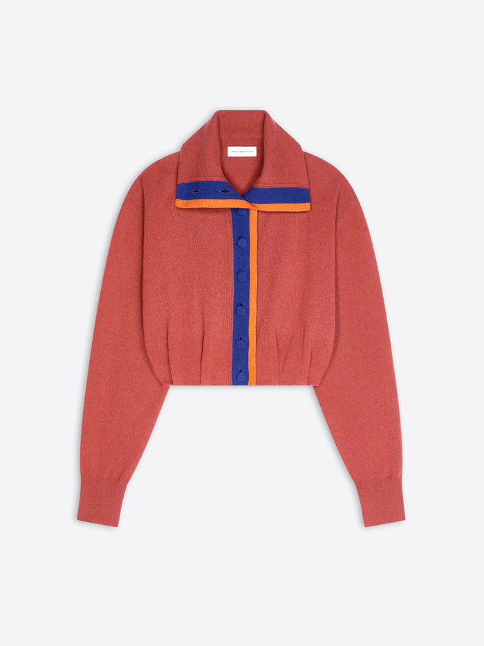 A cropped knit cardigan in a muted terracotta, featuring a wide collar with blue and orange striped collar and trim