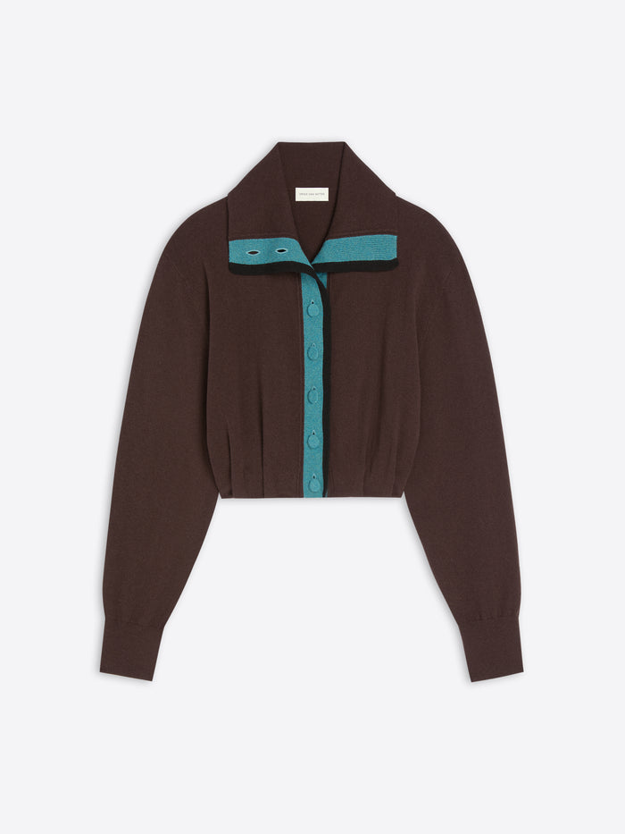 A dark brown cropped knit cardigan with long sleeves, featuring a teal button placket and a matching teal collar detail, displayed on a light gray background.