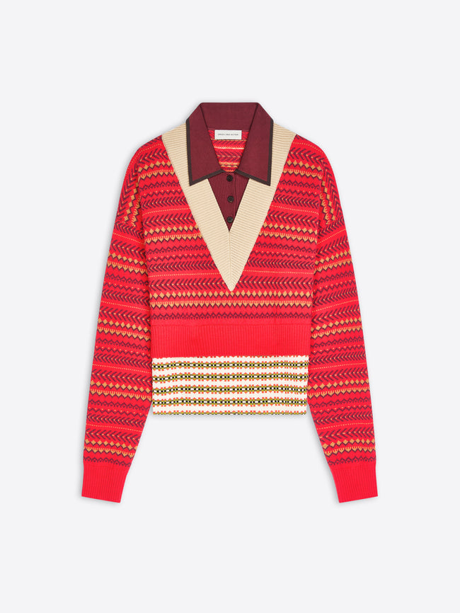 A cropped knit sweater with a geometric pattern, featuring a contrasting burgundy V-neck collar displayed on a light gray background.