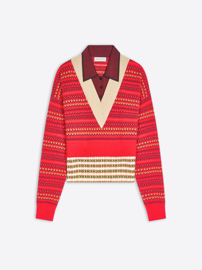A cropped knit sweater with a geometric pattern, featuring a contrasting burgundy V-neck collar displayed on a light gray background.