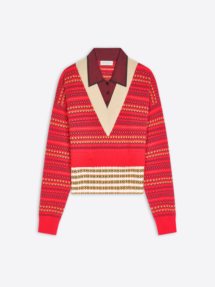 A cropped knit sweater with a geometric pattern, featuring a contrasting burgundy V-neck collar displayed on a light gray background.
