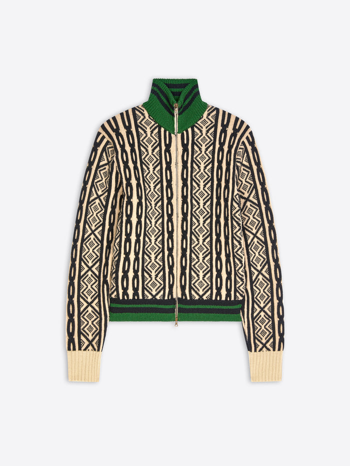 A cropped knit zip-up jacket featuring a cream and black geometric pattern, a solid green collar and hem, shown against a light gray background.