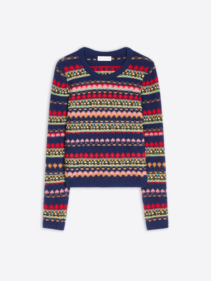 A cropped long-sleeve knit sweater with a multicolor pattern on a navy blue base, displayed flat against a light gray background.