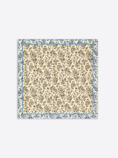 A square scarf with a dense floral print, featuring a cream center and a wider outer border in muted green and blue tones, shown flat against a light gray background.
