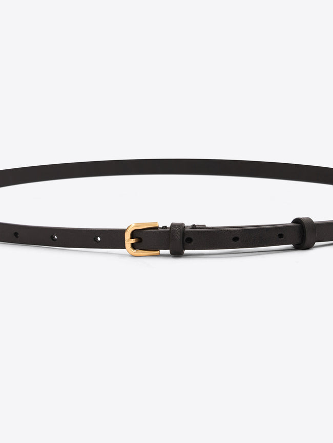 Close-up of a slim dark brown leather belt with a small gold-toned buckle on a light gray background.
