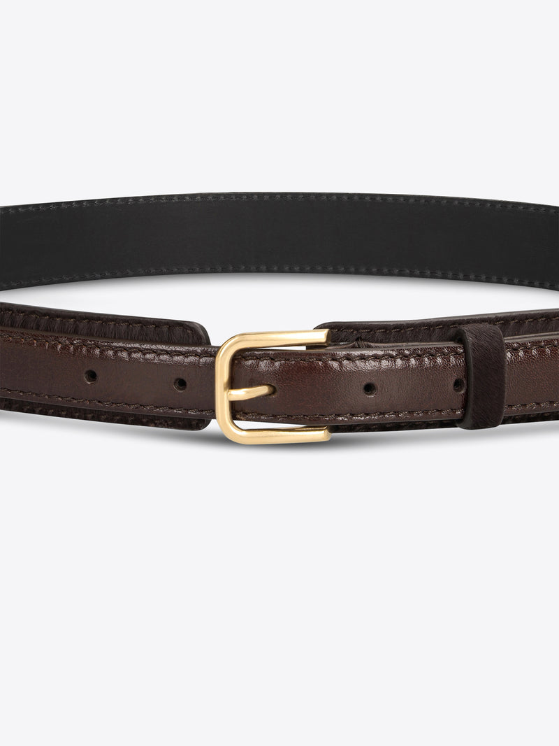 Close-up of a dark brown textured belt with smooth leather trim and a gold-toned buckle on a light gray background.
