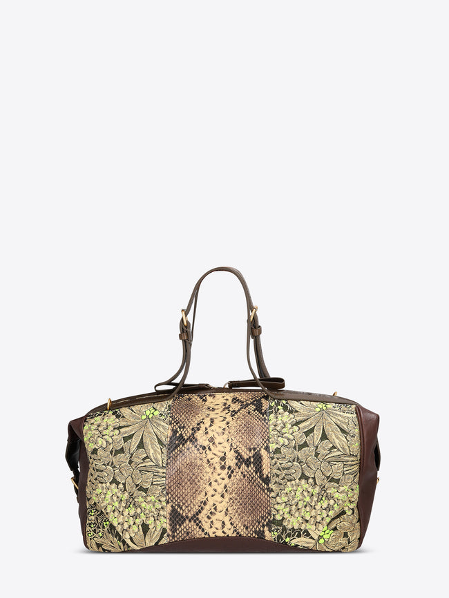 Structured duffle bag with dark brown leather trim, a tan snakeskin-effect center panel, and black-and-gold floral jacquard sides with green accents on a light gray background.