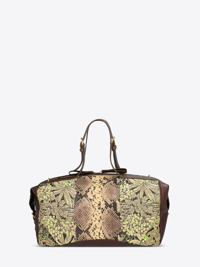 Structured duffle bag with dark brown leather trim, a tan snakeskin-effect center panel, and black-and-gold floral jacquard sides with green accents on a light gray background.