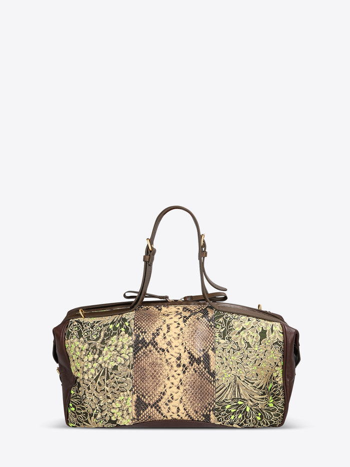 Structured duffle bag with dark brown leather trim, a tan snakeskin-effect center panel, and black-and-gold floral jacquard sides with green accents on a light gray background.