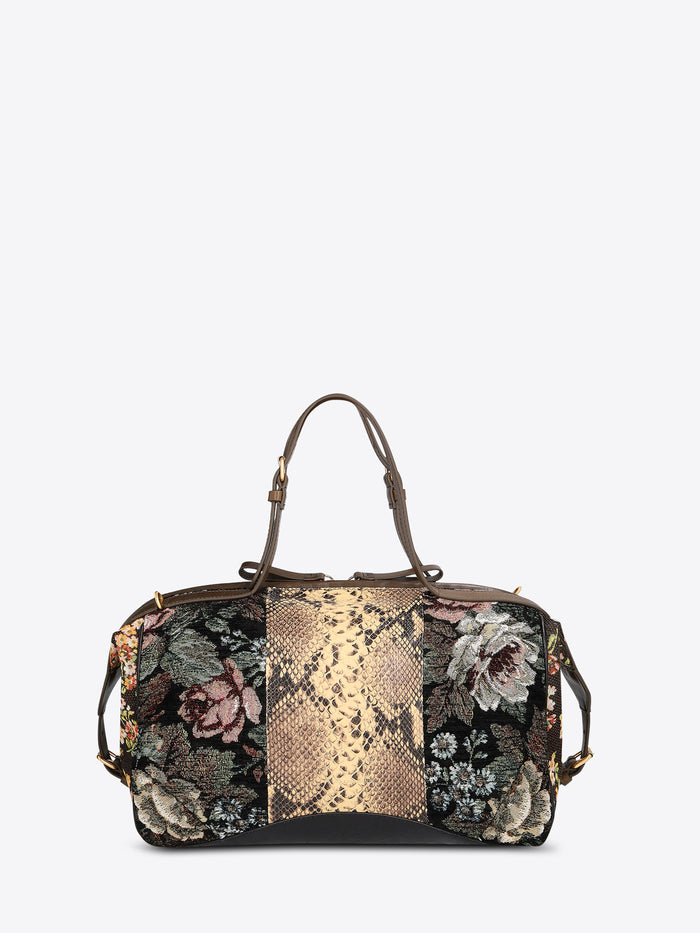 Structured floral jacquard duffle bag with a tan snakeskin-effect center panel, dark brown leather trim, and top handles on a light gray background.