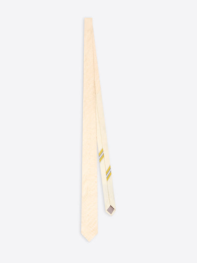 A cream-colored tie with a subtle textured pattern and two thin yellow diagonal stripes near the tip, displayed against a light gray background.