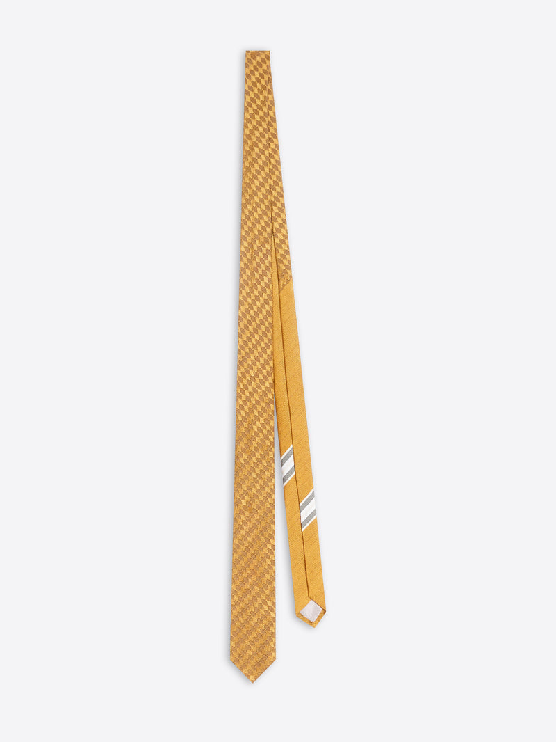 A tie in a mustard color, featuring a fine diagonal textured pattern on the main blade and two thin white diagonal stripes on the narrow tail, displayed against a light gray background.