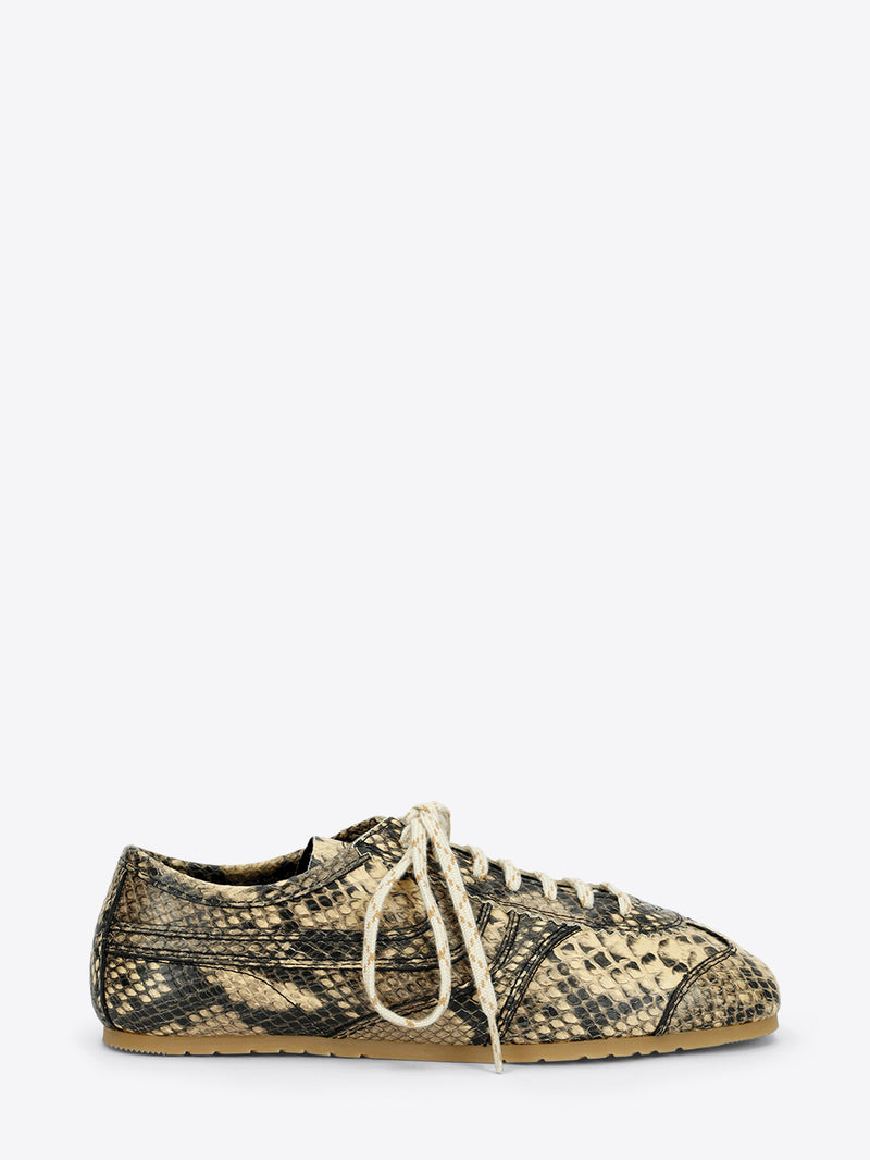 Beige and black snakeskin-effect lace-up sneaker with cream laces and a slim gum sole on a light gray background.