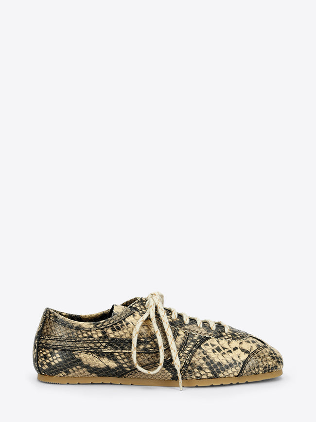 Beige and black snakeskin-effect lace-up sneaker with cream laces and a slim gum sole on a light gray background.