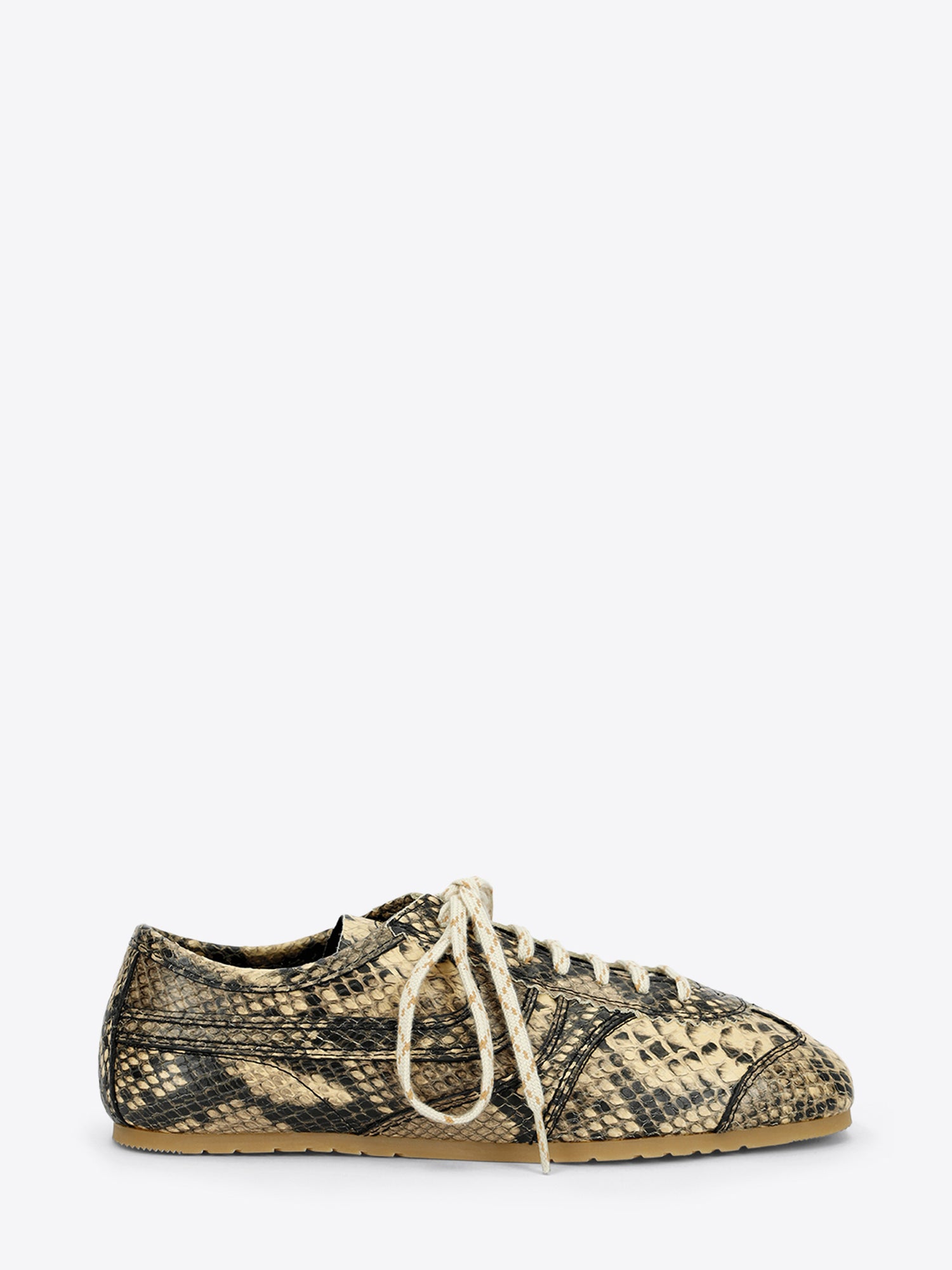 Beige and black snakeskin-effect lace-up sneaker with cream laces and a slim gum sole on a light gray background.