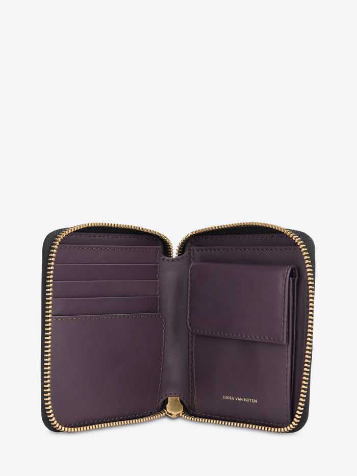 A small zip-around wallet featuring a dark purple leather interior, gold-tone zippers, and multiple card slots, shown open against a light gray background.