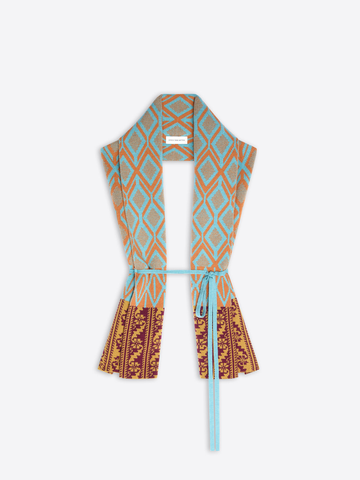 A lightweight open-front wrap style scarf-top with a light blue tie belt, featuring a turquoise and orange geometric diamond pattern on the upper body and a rust red and gold floral pattern on the lower part, shown against a light gray background.