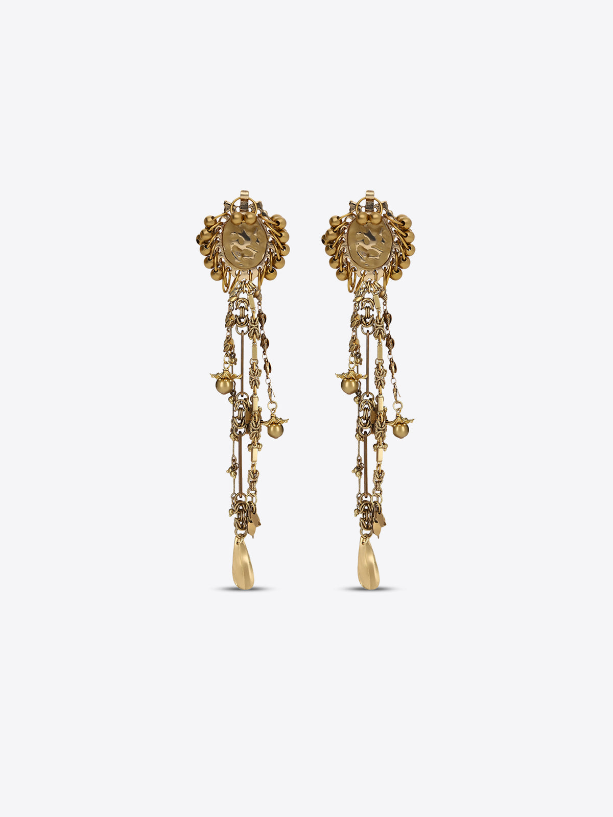 Pair of old brass drop earrings with oval medallions, cascading chains, floral charms, and teardrop pendants on a light gray background.