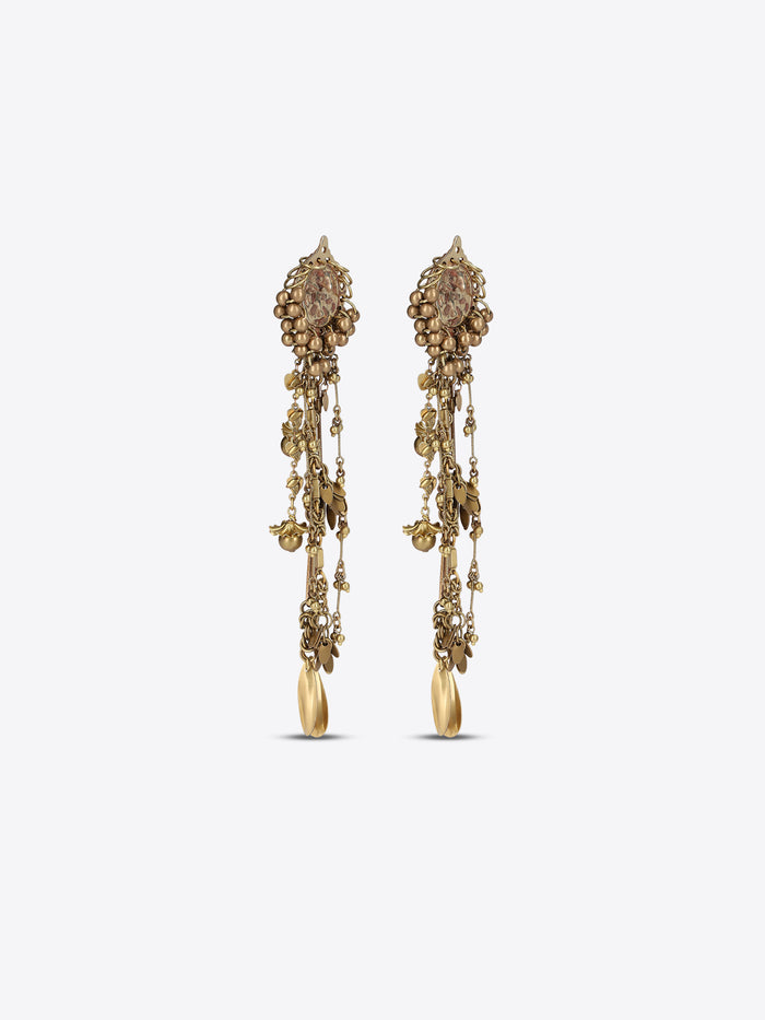 Pair of old brass drop earrings with oval medallions, cascading chains, floral charms, and teardrop pendants on a light gray background.