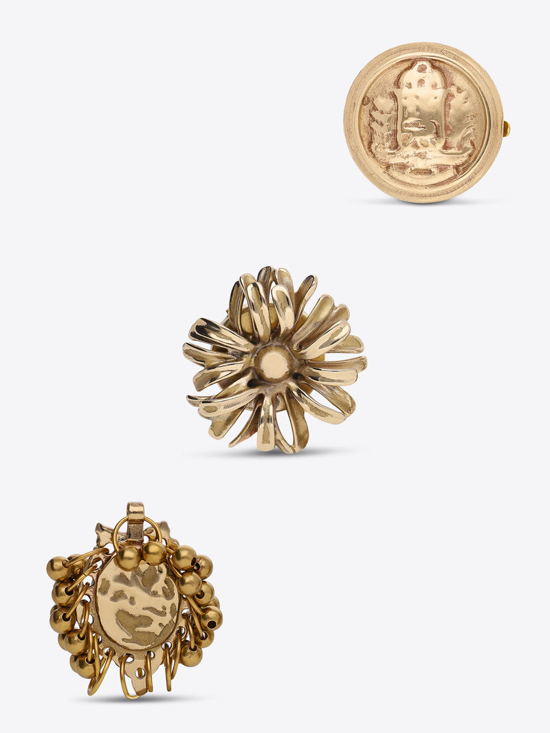 Three-piece gold-toned button cover set featuring a round medallion, a flower-shaped design, and a grape-cluster design with a central oval charm, shown on a light gray background.