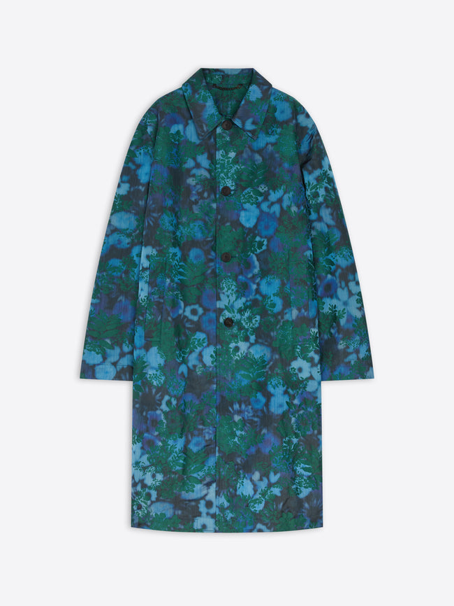 A long-sleeve button-front coat with a pointed collar, featuring an all-over abstract floral pattern in shades of blue, teal, and green, displayed against a light gray background.