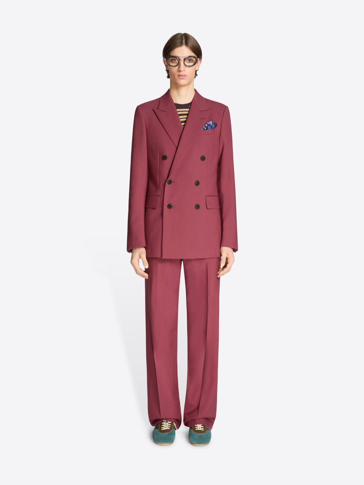 Person wearing a burgundy suit with a white background