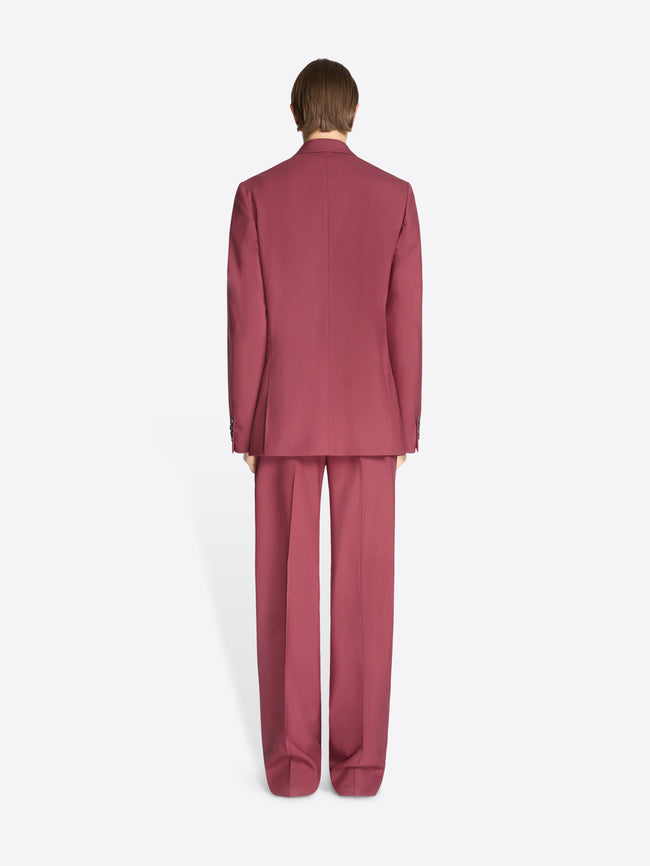 Person wearing a burgundy suit on a white background