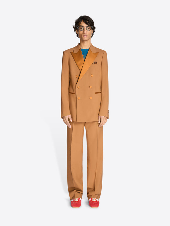 Person wearing an orange suit on a white background