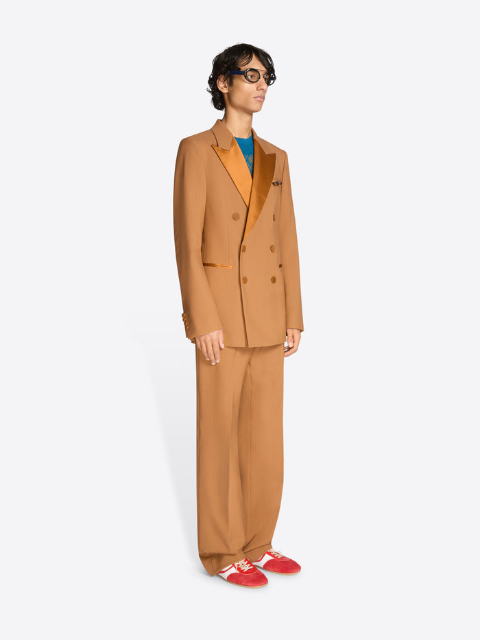 Person wearing an orange suit on a white background
