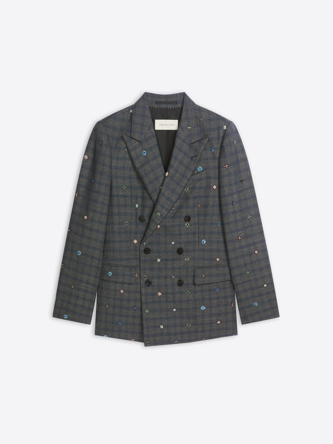 Plaid blazer with colorful embellishments on a white background