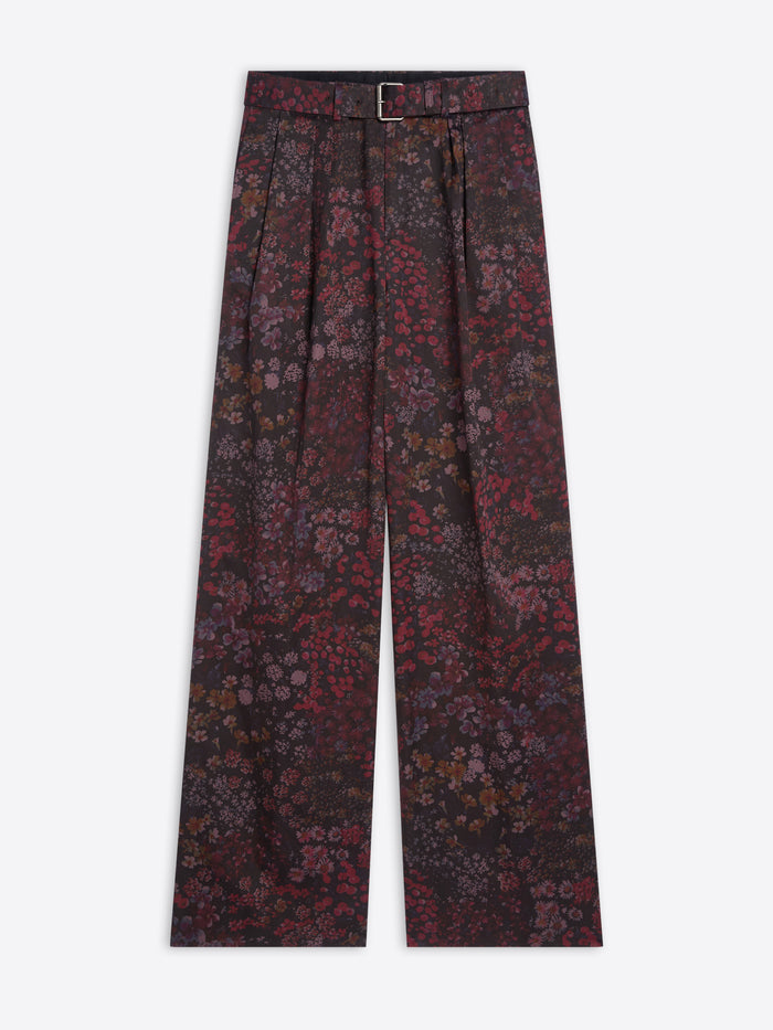 Floral patterned pants with a belt on a white background