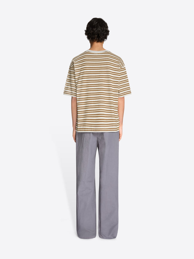 Back view of a person wearing a striped t-shirt and gray pants on a white background