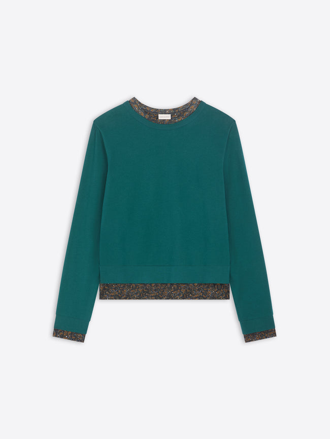 Teal sweater with patterned hem on a white background