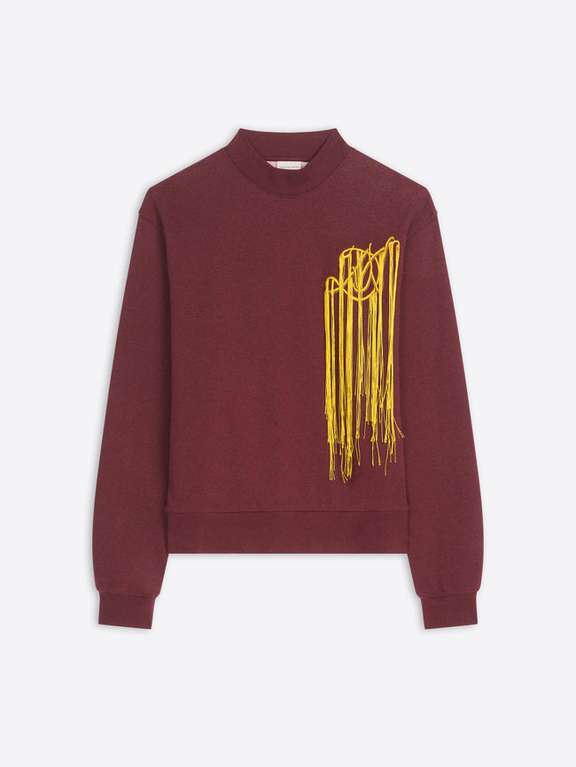 A crewneck sweatshirt in maroon with a yellow abstract embroidery on the left chest, displayed against a light gray background.